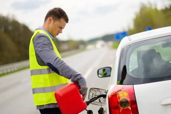 roadside fuel assistance technician refuelling car